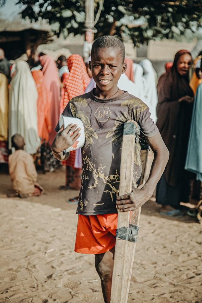 Disabled Boy Holding a Bowl